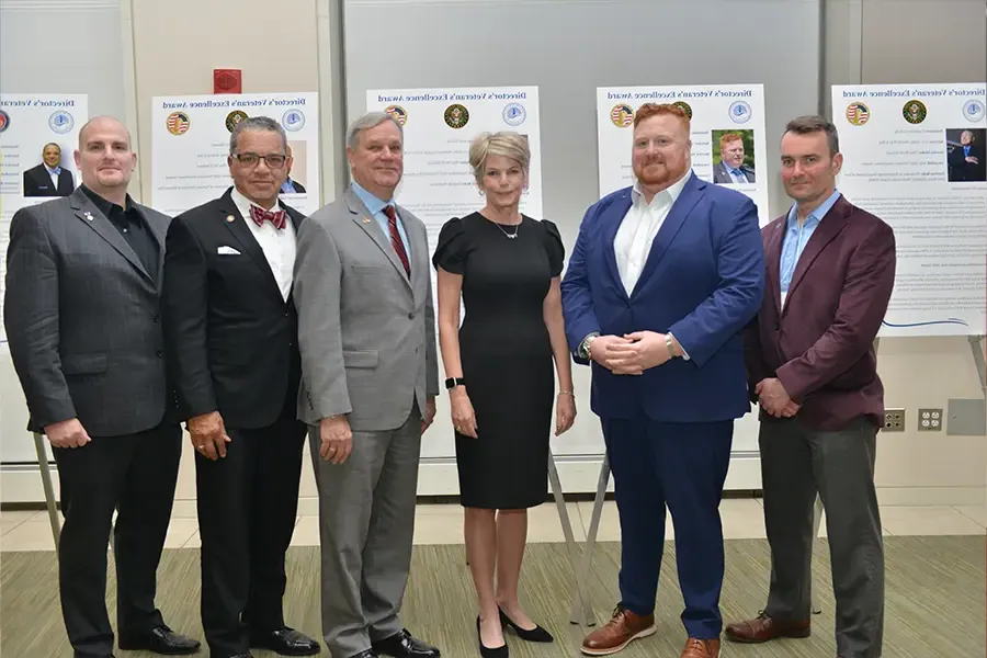 Group of veterans stand for the Honor a Veteran award.